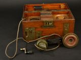 an old wooden box with a phone inside of it