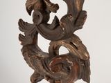 a wooden clock on a stand on a white background