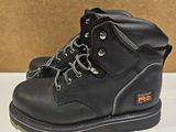 a pair of black work boots on a white surface