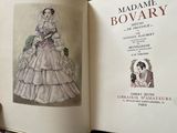 someone is holding a book with a drawing of a woman in a dress