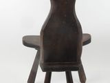 a wooden chair with a wooden seat and a wooden table