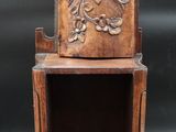 a small wooden shelf with a shelf on top of it
