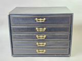 an image of a black and gold chest of drawers on a white background