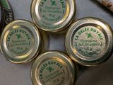 four tins of beer sitting on top of a table next to a bottle
