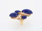a close up of a gold ring with lapis and diamonds