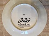 a white plate with a black writing on it sitting on a table