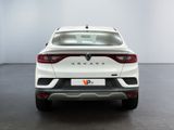 the rear end of a white car in a white room