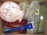 a box full of glass vases and other glass items