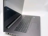 a laptop that is open on a white table