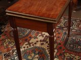 a small wooden table with a drawer on top of it
