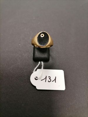 a close up of a gold ring with an evil eye on it