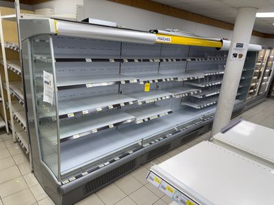 many empty shelves in a store that are empty