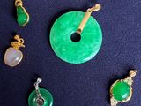 several pieces of jewelry including a donut, a pendant, and a pendant