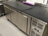 a kitchen with stainless steel appliances and a black counter top