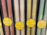 several different colored candles are in a display case