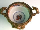 a small bowl with a handle on a white table