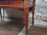 a wooden table that is sitting on a hard wood floor