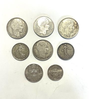 six different types of silver coins are arranged in a circle