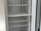 a white refrigerator with a door open in a room