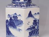 blue and white porcelain vase with a landscape scene on the lid