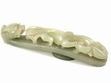 a white jade hair clip with flowers on it