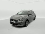 Une voiture grise est garée dans une pièce blanche au sol blanc.
