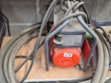 a red and black hose attached to a red and black machine