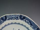 a blue and white plate with a picture of a cat on it