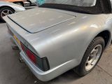 an image of a silver sports car parked in a garage