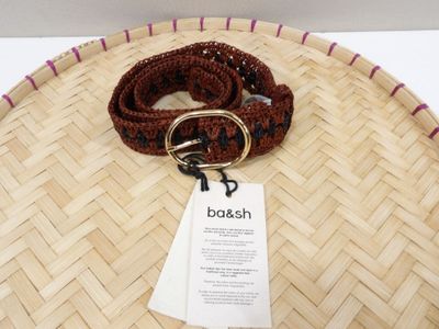 a brown belt with a gold buckle and a tag on it