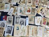 a lot of old postcards on a black table