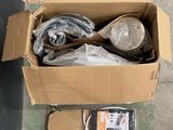 a cardboard box filled with assorted items sitting on the floor