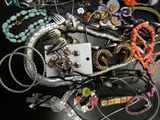 a pile of jewelry on a table with a tag