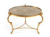 a gold coffee table with a marble top on a white background