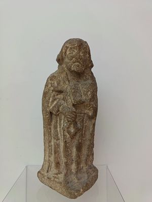 statue of a woman holding a child on a glass shelf