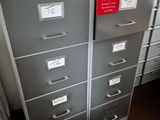 a lot of filing cabinets in this room with labels on them