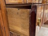 a wooden dresser with a drawer in the middle of it