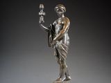 a bronze statue of a man holding a bird on a marble base
