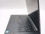 a laptop with a black keyboard on a white surface