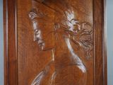 an image of a wooden plaque with a woman ' s head on it