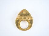 a gold ring with a picture on it on a white surface