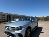 a silver mercedes suv parked in front of a building