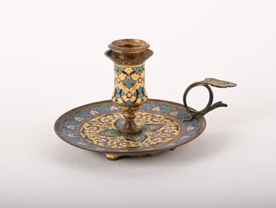 an antique brass candle holder with a blue and yellow design