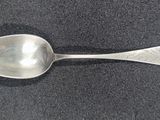 a spoon that is sitting on a black surface