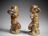 a pair of bronze figurines of a boy and a girl