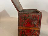 a small wooden box with a lid that has a design on it