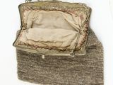 a purse that is sitting on top of a pile of carpet