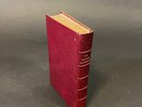 a small red book sitting on top of a table
