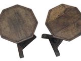 two wooden stools that are sitting next to each other