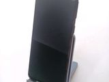 a cell phone that is on a stand on a table
